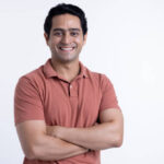 happy laughing guy posing with arms folded